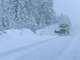 snowplow clearing roads in a blizzard