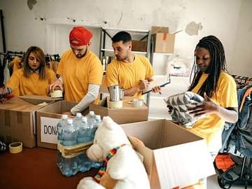 a group of volunteers arranging donations
