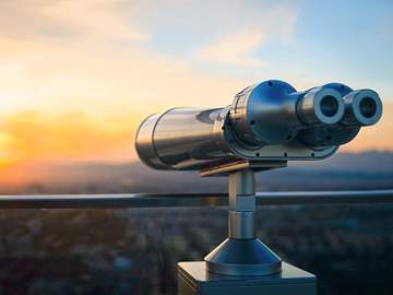 binoculars in observatory looking out on city