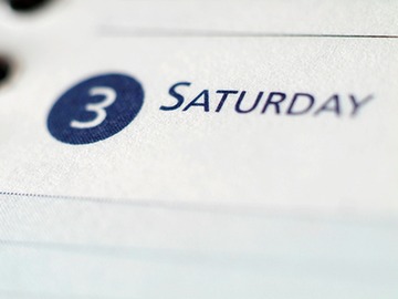 detail of paper page by page calendar showing the number three and the word saturday