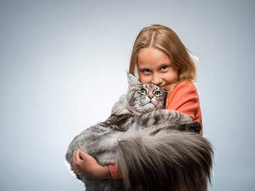 girl holding extremely fluffy cat