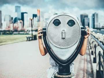 girl using coin operated binoculars