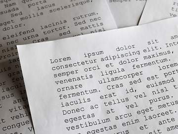 orem ipsum dolor sit amet concept selective focus photo of paper sheets with publishing and graphic design placeholder text on them