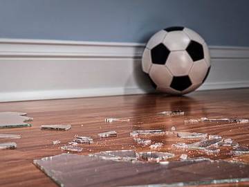 soccer ball next to broken glass