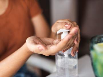 woman using hand sanitizer
