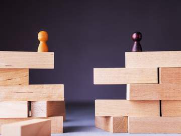 wood blocks with figures on them apart from each other
