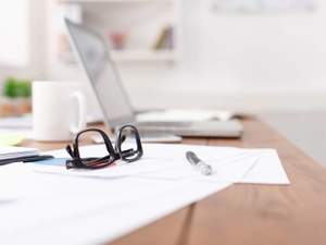 eyeglasses laptop and papers