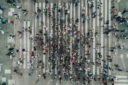 crowd of people seen from above crossing a street