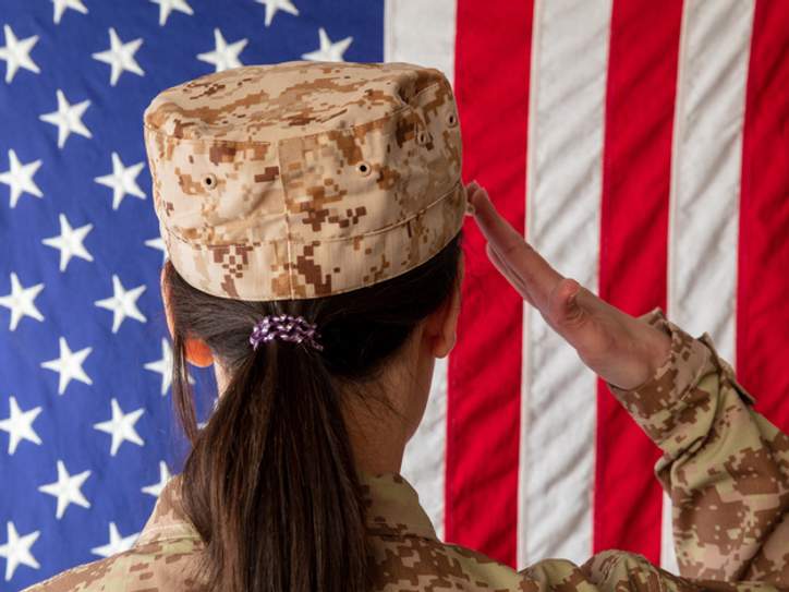 Member of the US military holds up the signed practice worm jersey