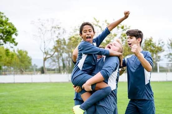 boys soccer team cheering a goal