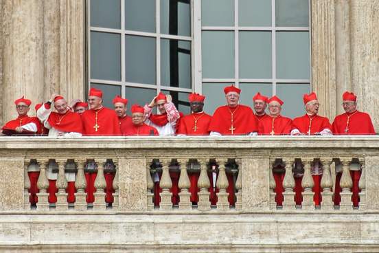 cardinals in red vestments on a balcony