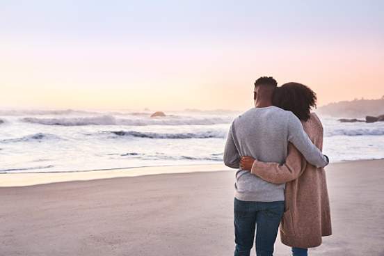 couple watching sunset on beach