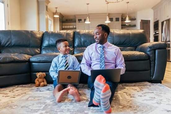 father and son on laptops