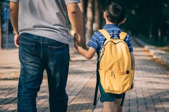 man holding sons hand