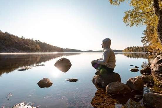 man meditation by lake