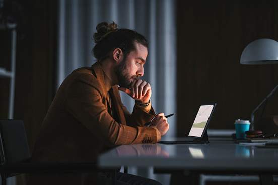 man sitting at computer late at night