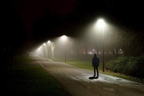 man walking alone at night