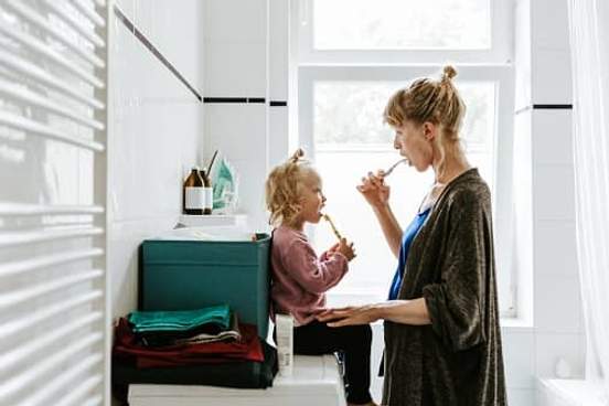 mother and daughter brushing teeth