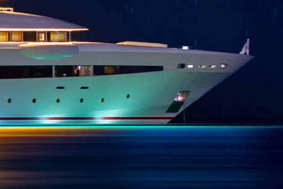 nighttime scene of a large yacht anchored