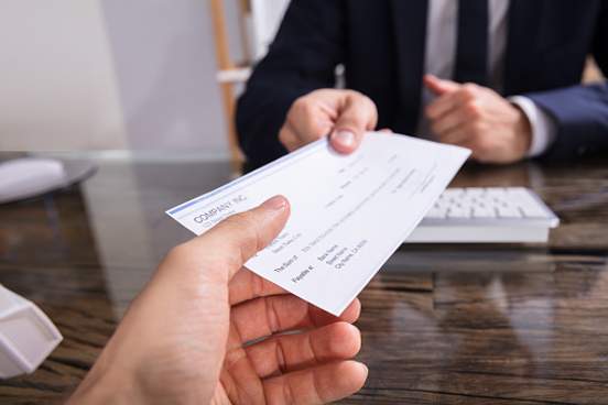person getting paycheck at work