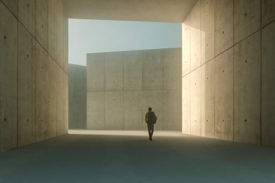 person walking alone under brick building