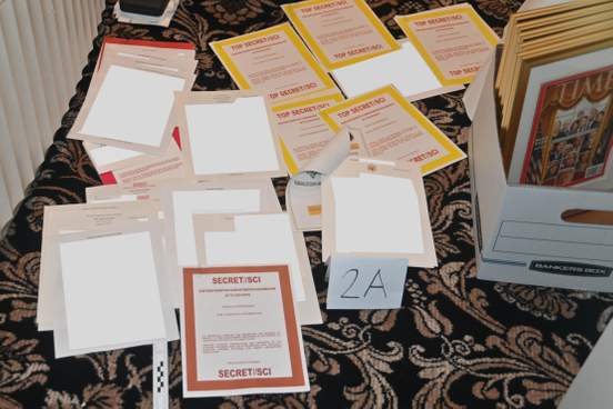 photograph of various documents seized during a mar-a-lago search the documents laid on a carpeted floor next to a marker 2a