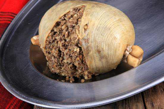 scottish haggis cooked for a burns night dinner against a royal stuart tartan
