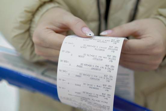 woman holding a paper receipt