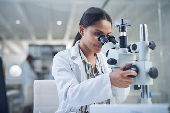 woman using microscope