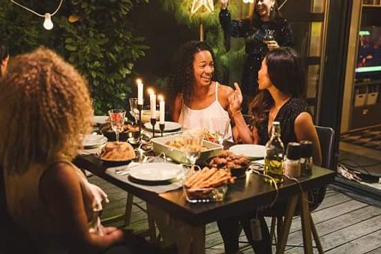 women talking at dinner