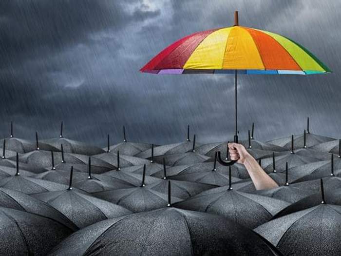 colorful-umbrella-among-black-umbrellas