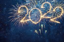 fireworks in a dark sky spell out 2022