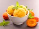 a-bowl-of-peach-sorbet-with-cut-peaches-next-to-it
