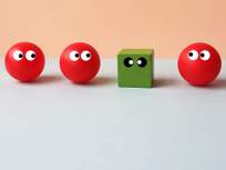 image of a green cube out of place in a lineup of red spheres
